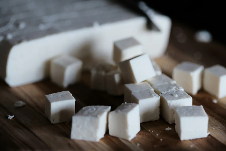 cubes of cut cheese next to a block of white cheese