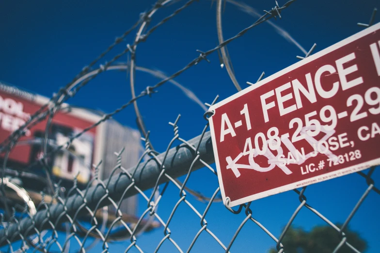 a fence that has some kind of sign attached to it