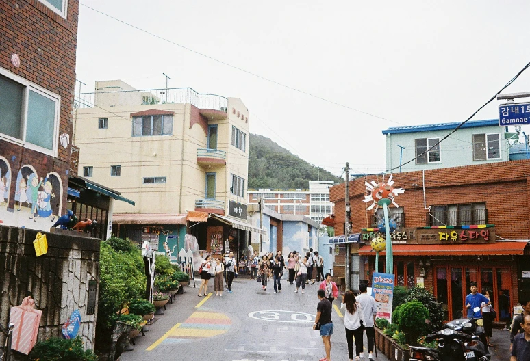 a street with shops and people walking along it