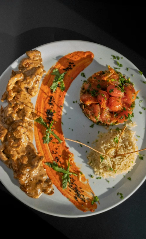 a white plate topped with food and vegetables