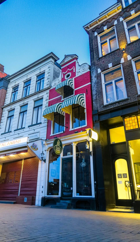 several different colored buildings on a city street