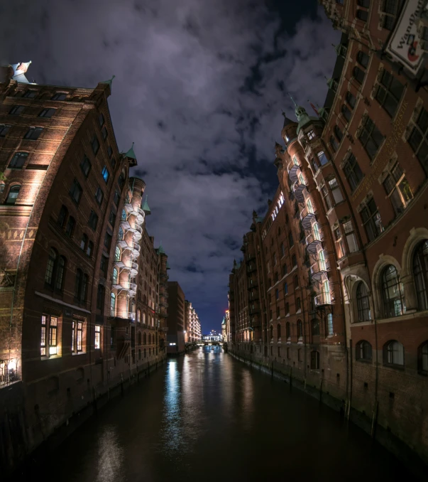 long narrow waterway illuminated with street lights at night