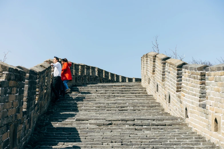 two people standing on some kind of stairway