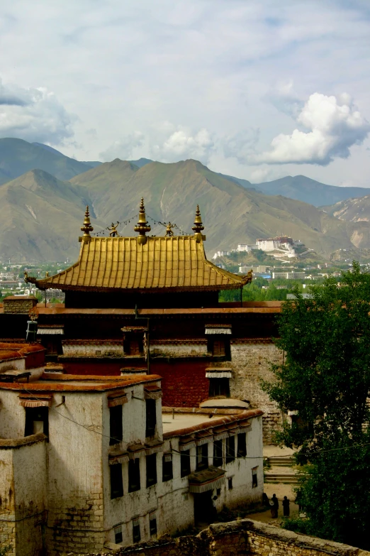 a building that has a golden roof and several roof tops