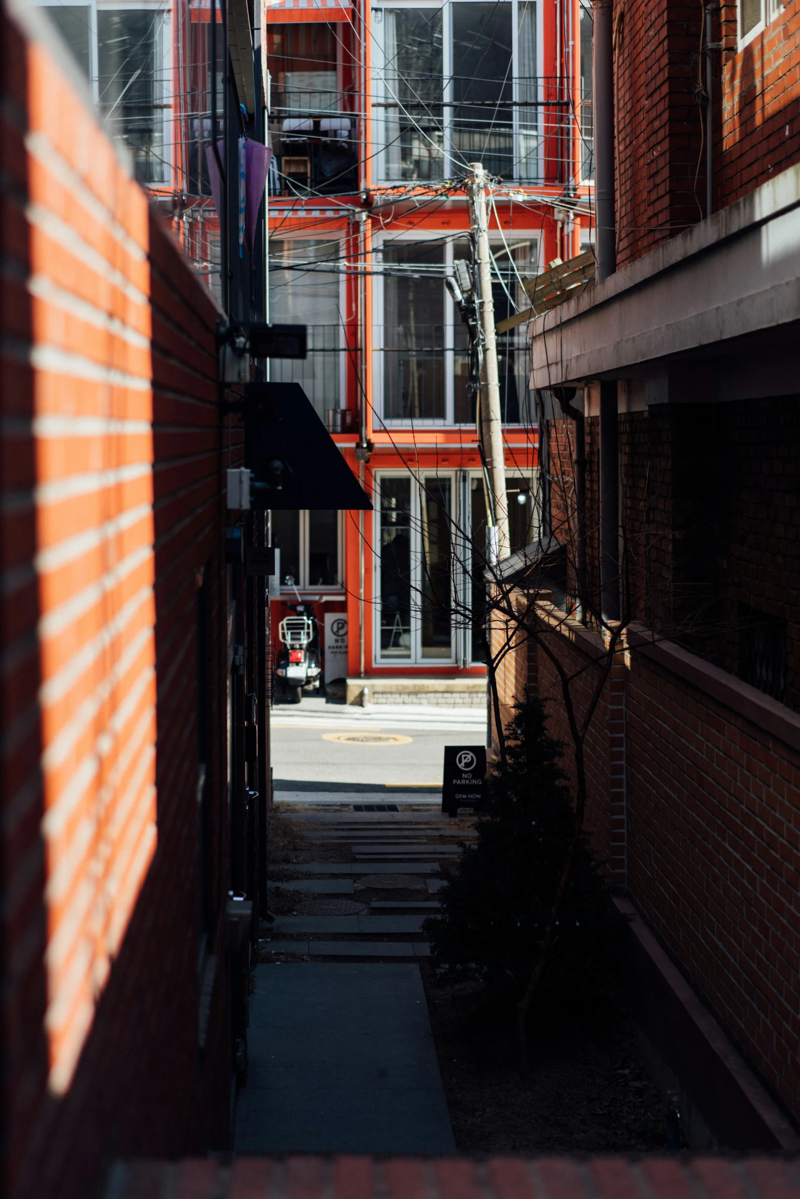 a truck drives down a street with orange and white apartments