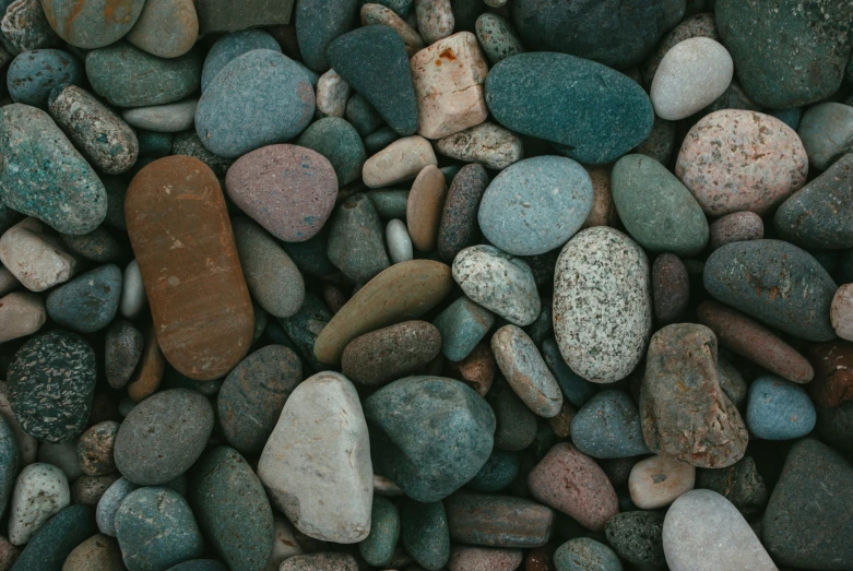 rocks and gravel are together with little grass