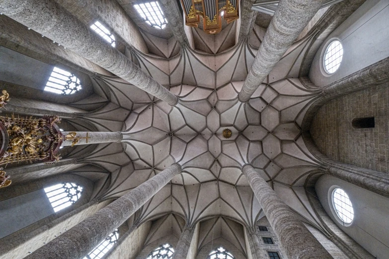 a cathedral has ornate architecture and multiple round windows