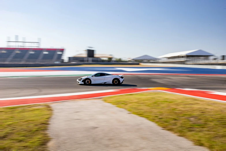 a sports car driving on a racing track