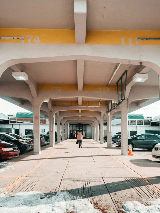 a person walks through an indoor parking lot