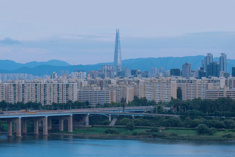 a bridge over water next to lots of tall buildings