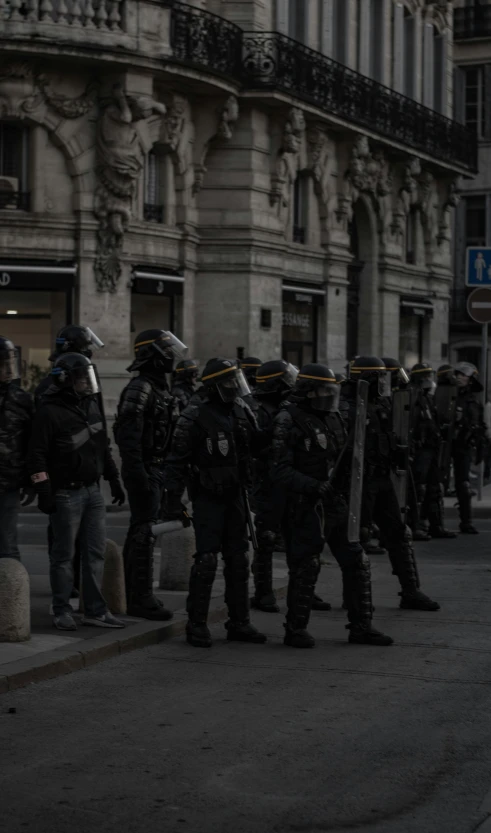 a group of armed men on street next to building