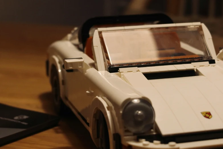 a toy white and black race car on a wooden surface