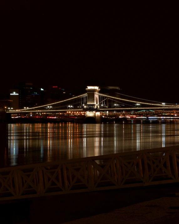 a large bridge crossing over a body of water at night