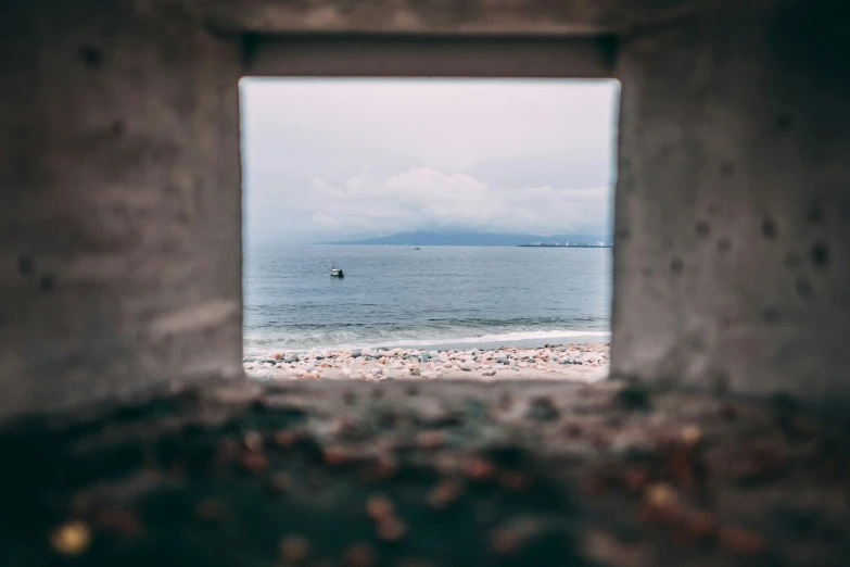 a beach view with a couple of ships on the ocean