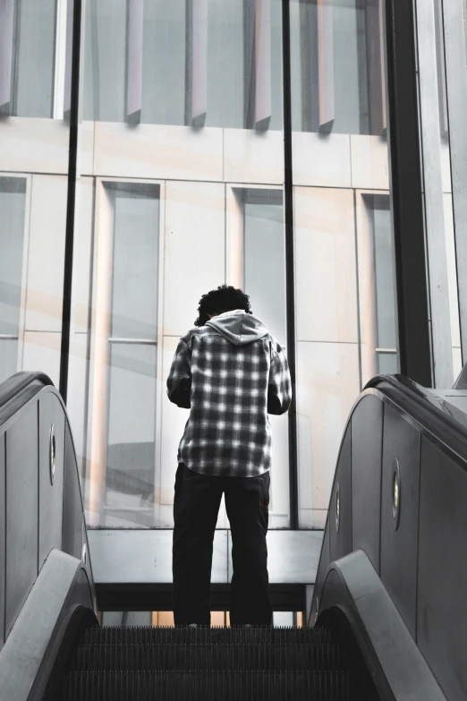 a person on the escalator staring out over the street