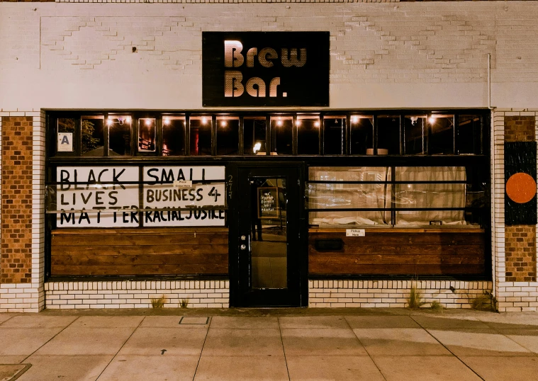 an empty sidewalk sits next to a brick bar