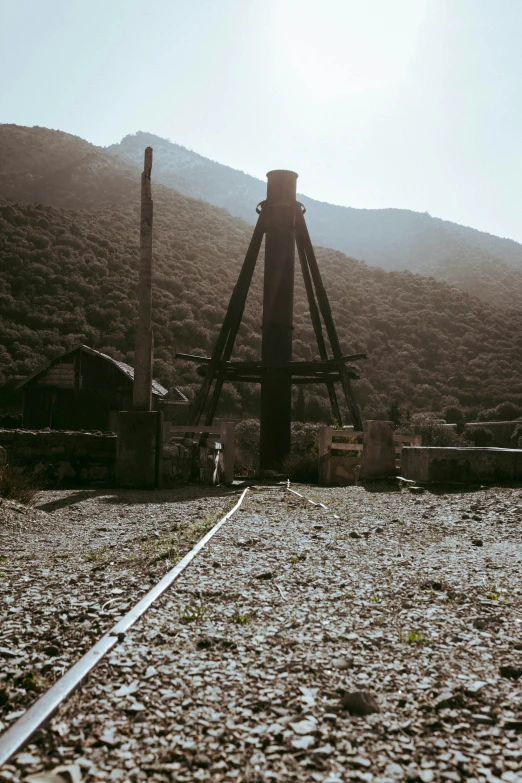 a train track in front of a mountainous area