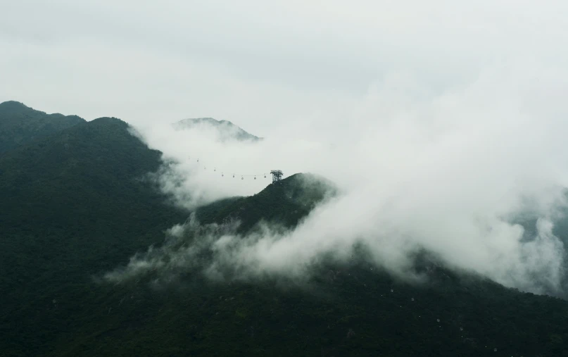 this is the mountain top covered in fog and low clouds