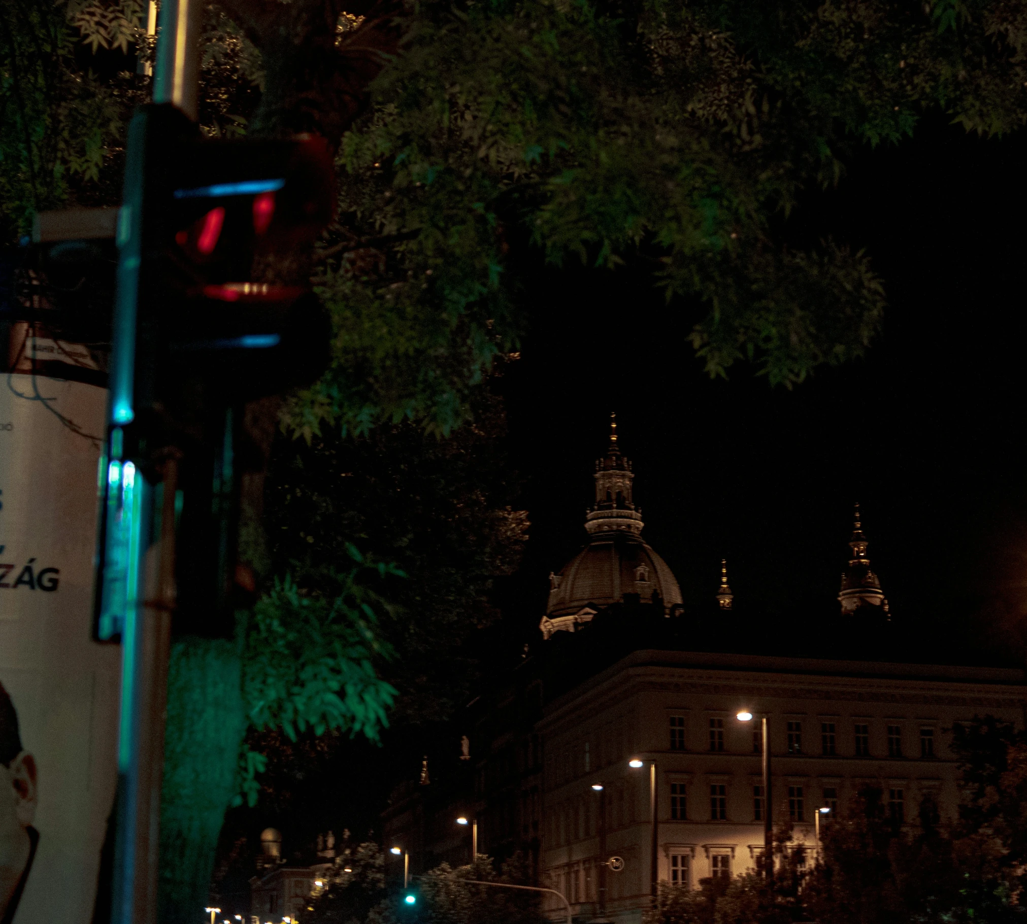 lights on a street near large buildings at night