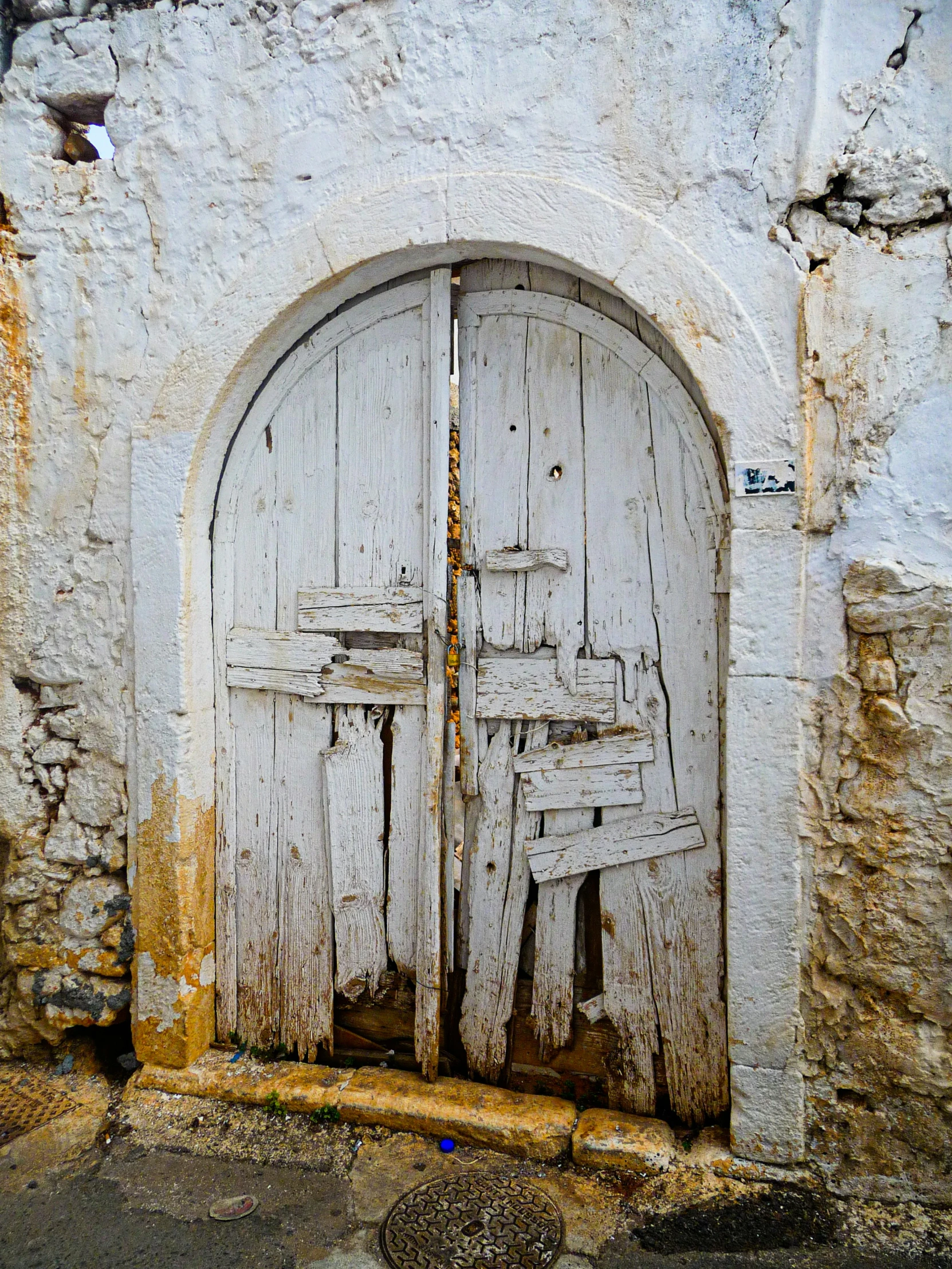 the door to the white stone house is closed