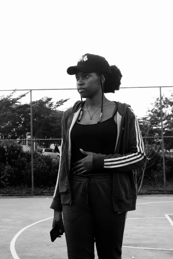 a young black woman holding a tennis racket