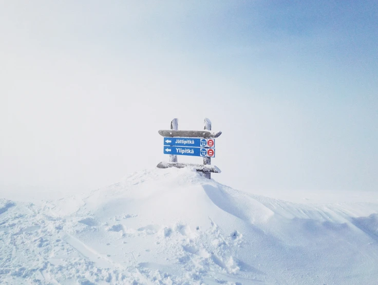 a billboard in the middle of snow covered ground