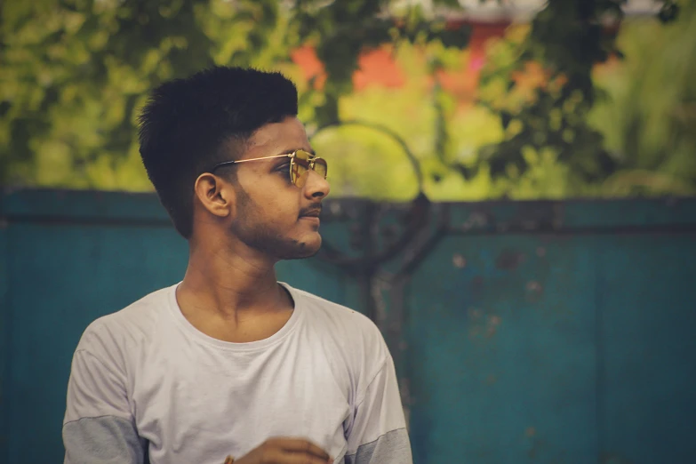 a young man wearing sunglasses and white shirt