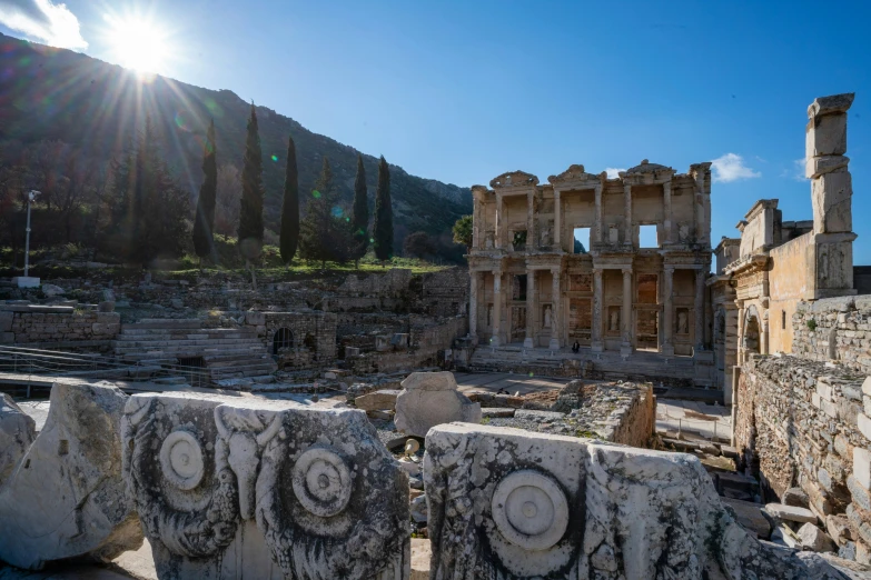 ruins in front of mountains are surrounded by ancient stone carvings