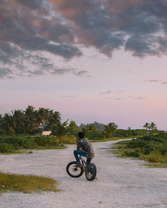 man riding a dirt bike down a path