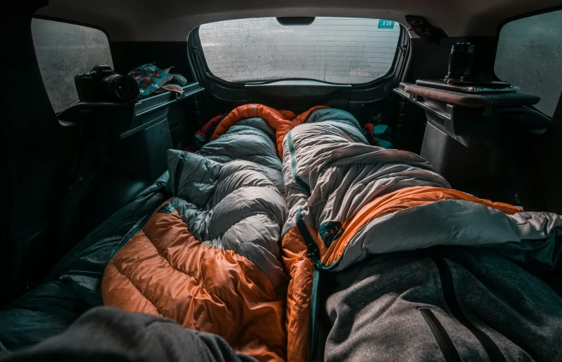 the back of a truck is filled with lots of sleeping bags