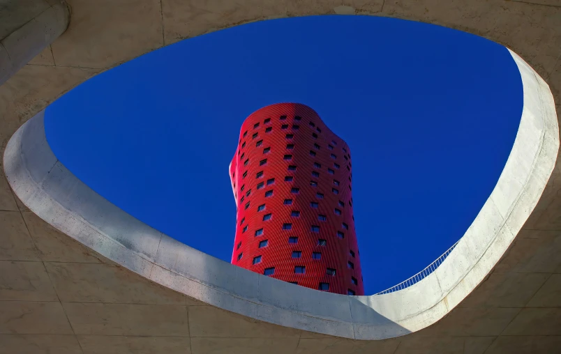 the top of a tall building next to a circular object