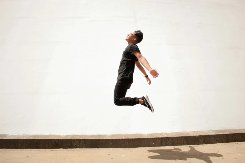 the young man in a black shirt is practicing tricks on his skateboard