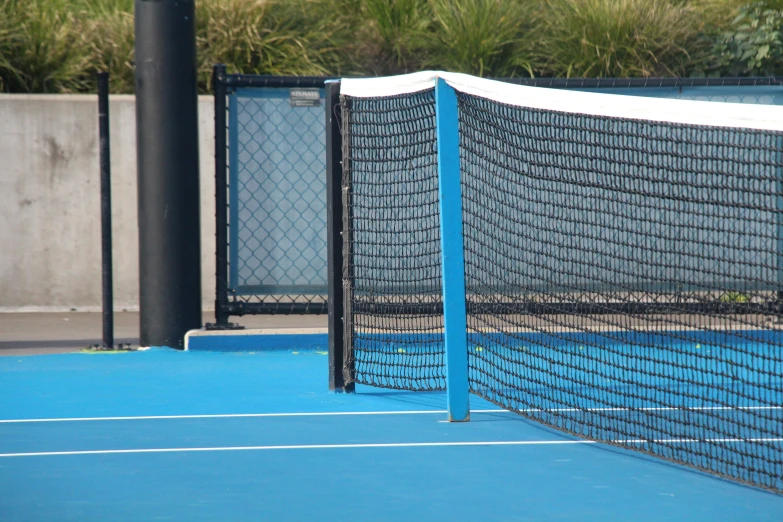 a blue tennis court with a net on it