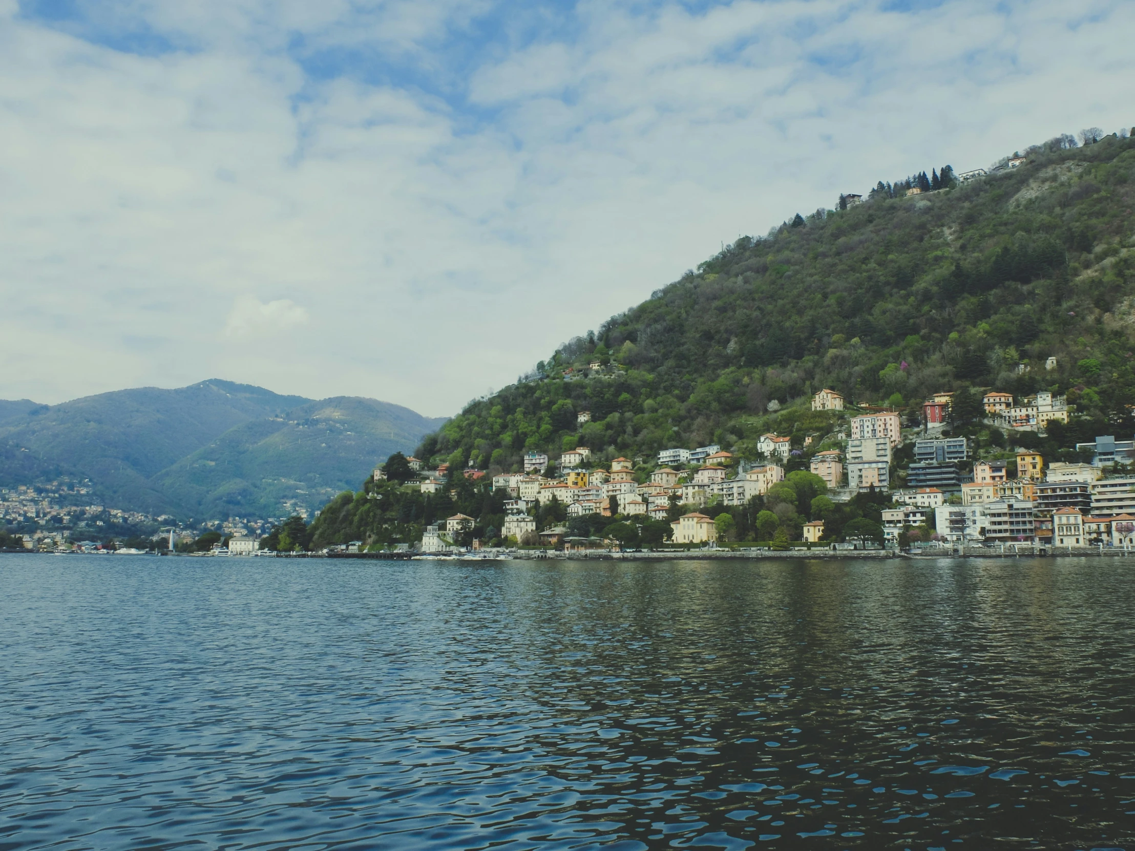 a small town on the side of a cliff next to the ocean