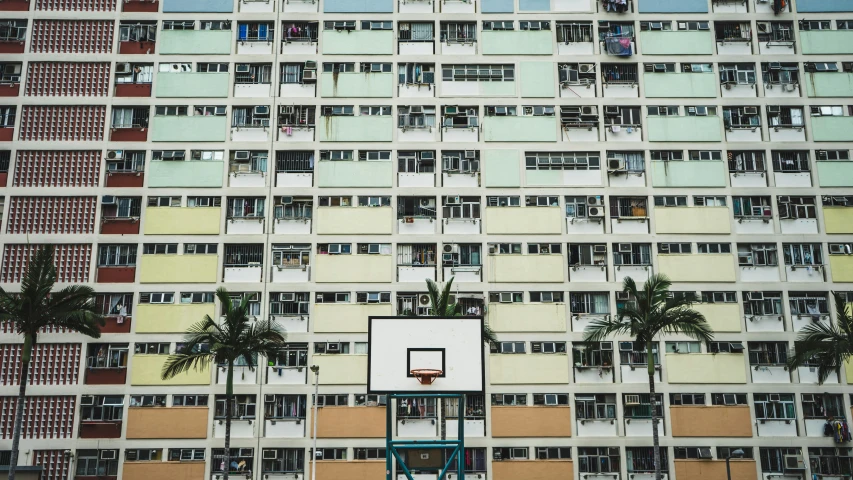 a basketball goal in front of an apartment building