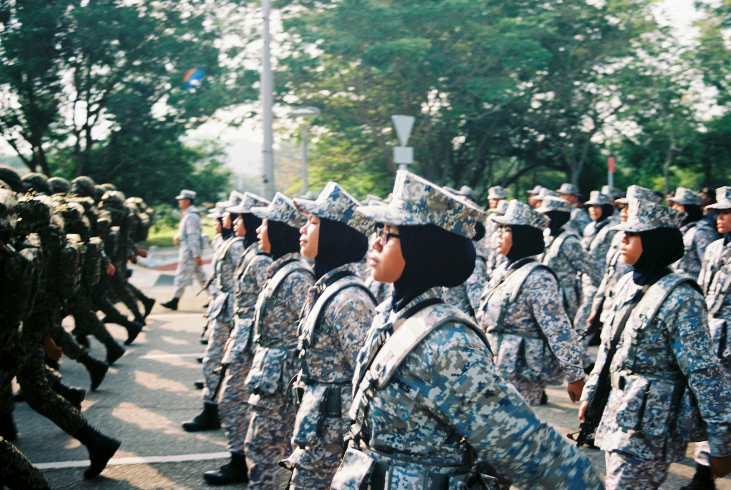 several soldiers marching together on the street