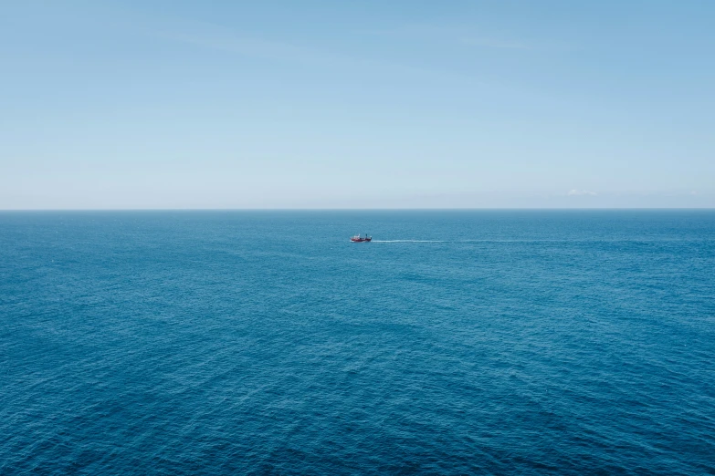 an ocean with two boats that are in the distance