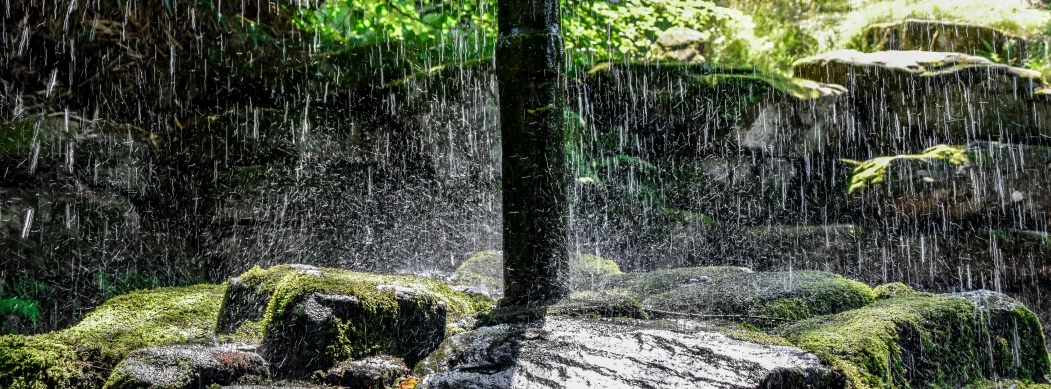 a waterfall of water next to some rocks