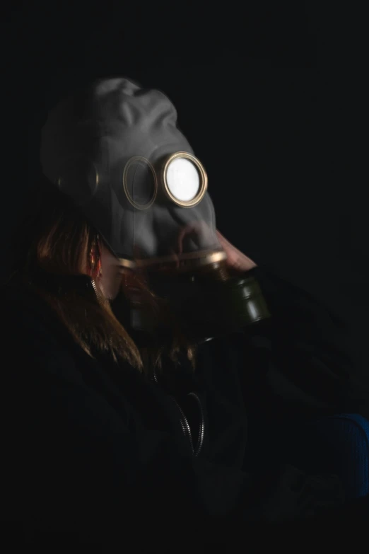 man with glowing gas mask in dark area