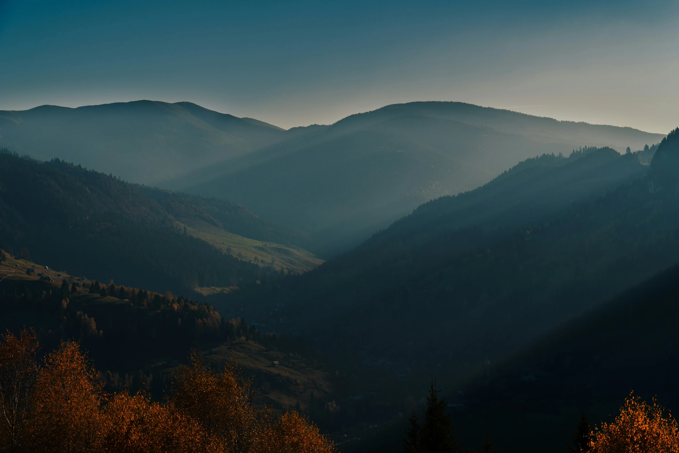 mountain tops during sunset with a hazy sky