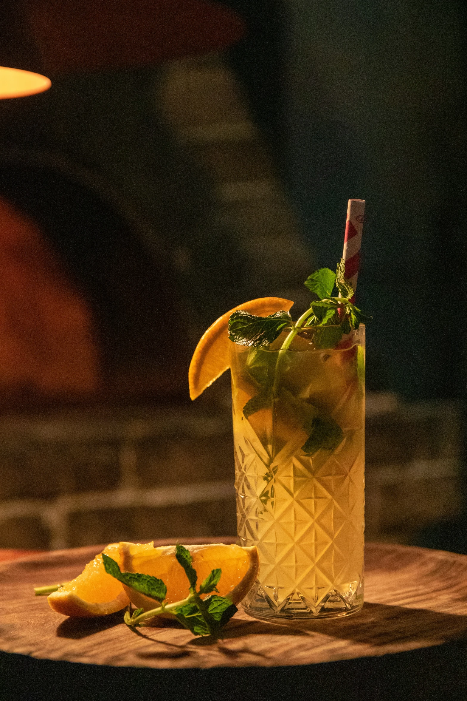 a drink on a table is garnished with lemon and mint