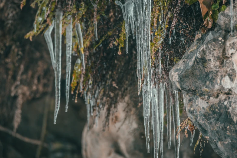 icicles have been suspended down on the rocks