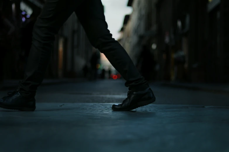 person walking down the street in a city at night