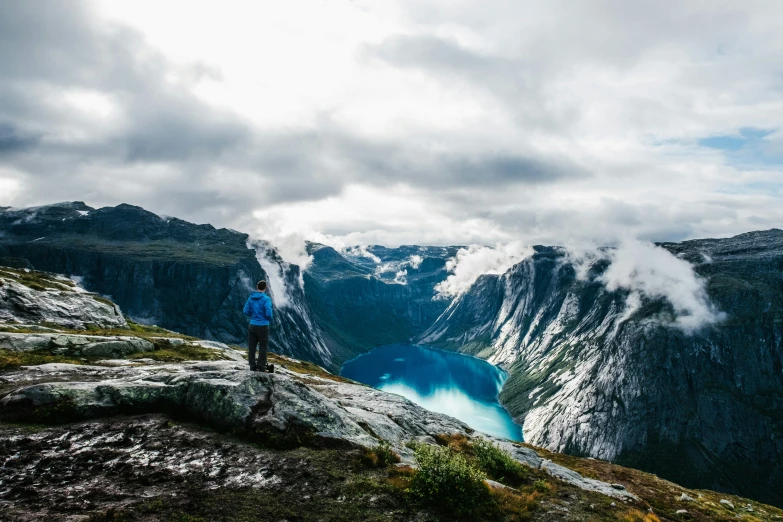 a man standing on the edge of a mountain