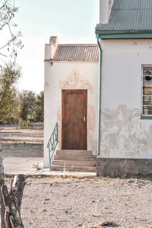 a brown door sits on the side of an old house