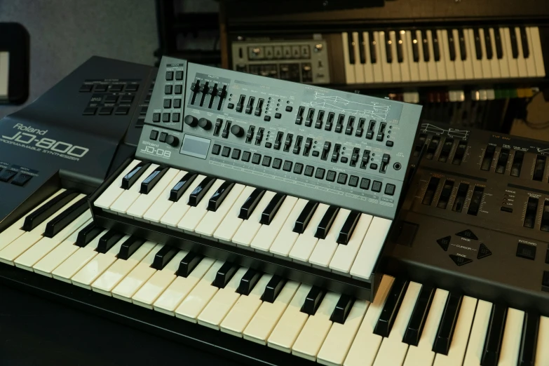 keyboard sitting with several other musical keyboards