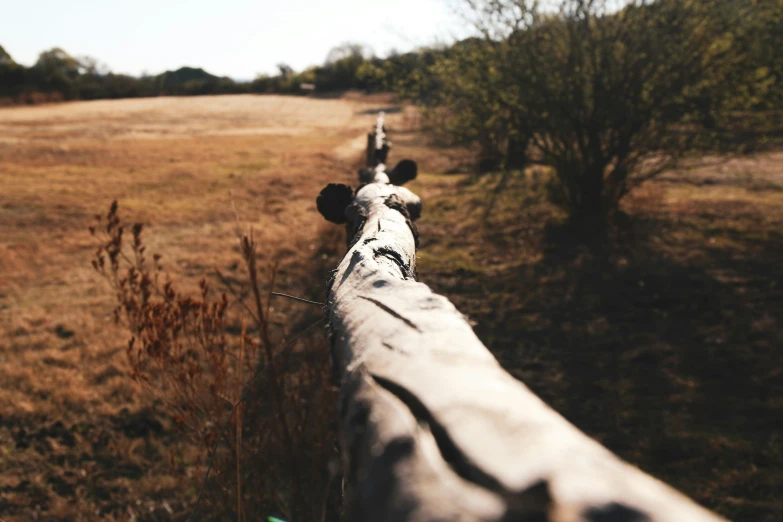 there is a close up po of a field with a metal fence