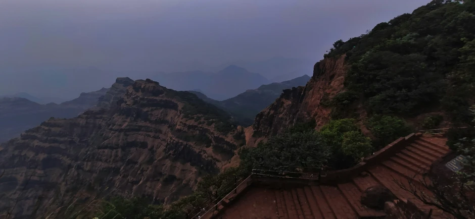 stairs along the side of a cliff in the mountains