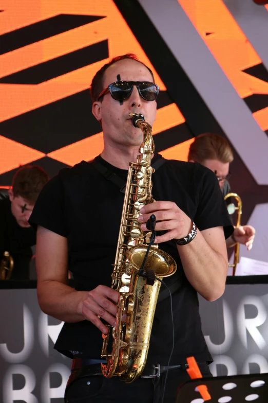 a man playing on a saxophone at an event