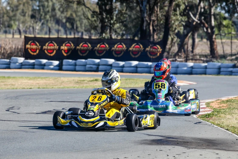 three small s racing carts on a paved track